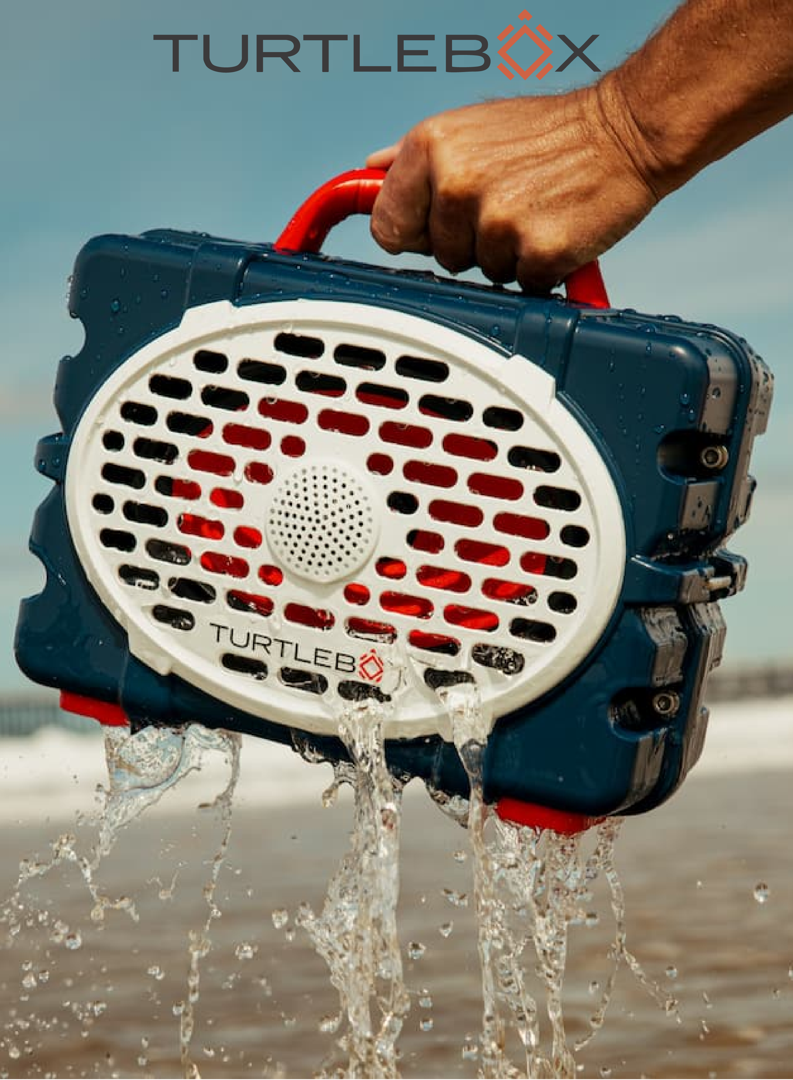 TurtleBox product being used with water splashing out, on a beach background.